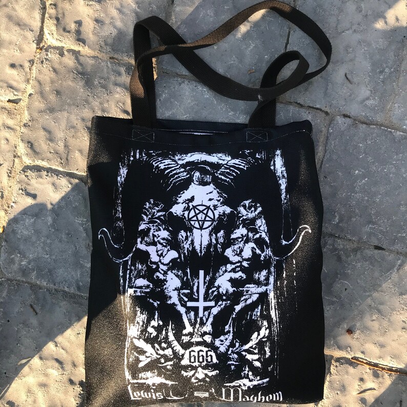 May include: Black tote bag with a white graphic print of a skull with a pentagram, a cross, and the number 666. The text "Levis - Mayhem" is printed at the bottom of the bag.