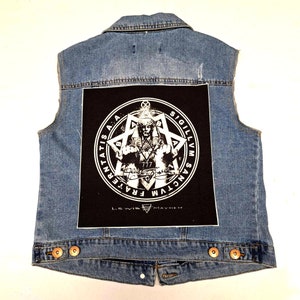 May include: A blue denim vest with a black patch on the back. The patch features a white pentagram with a figure in the center and the text "FRATER  SANCTVM  SIGILLVM  LEWIS  MAYHEM".