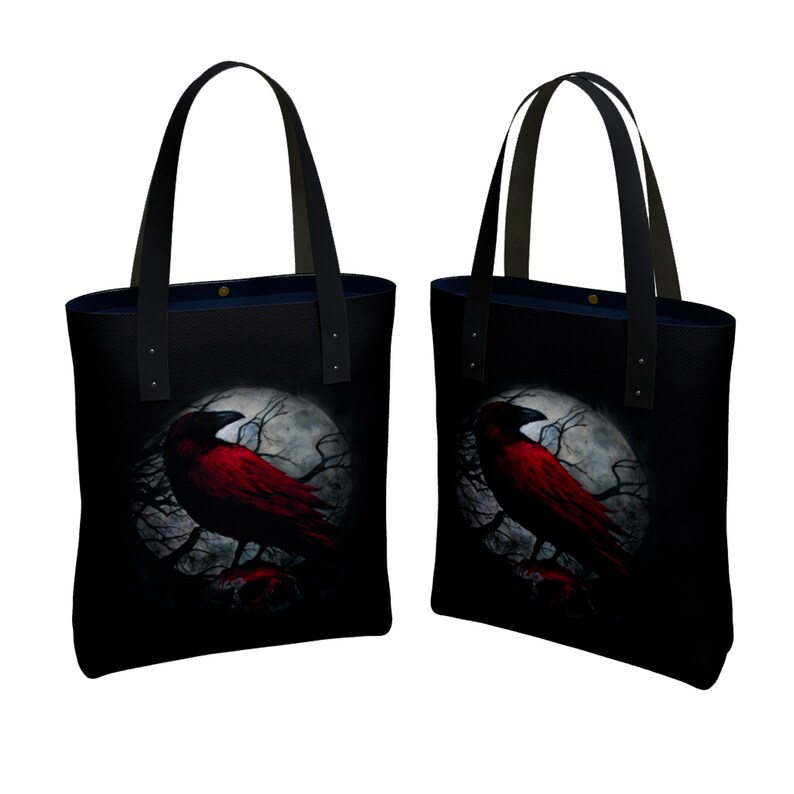 May include: Two black tote bags with red crow silhouettes on a moonlit background. The crows are perched on branches with a skull at the base of each tree.