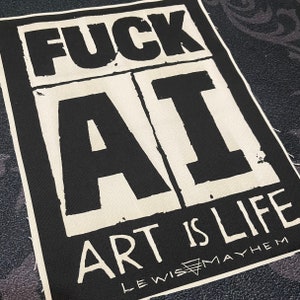 May include: Black and white patch with the text "FUCK AI ART IS LIFE" and the text "LEWIS MAYHEM" in a smaller font below.