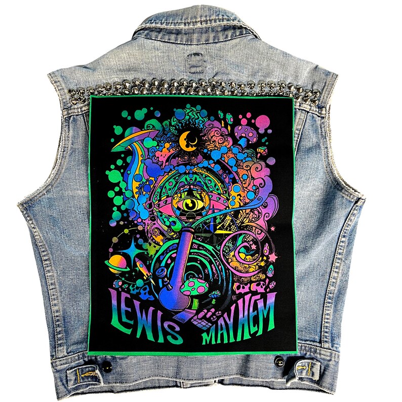 May include: A black denim vest with a colorful psychedelic patch featuring a large eye, a pipe, and the text "Lewis Mayhem".
