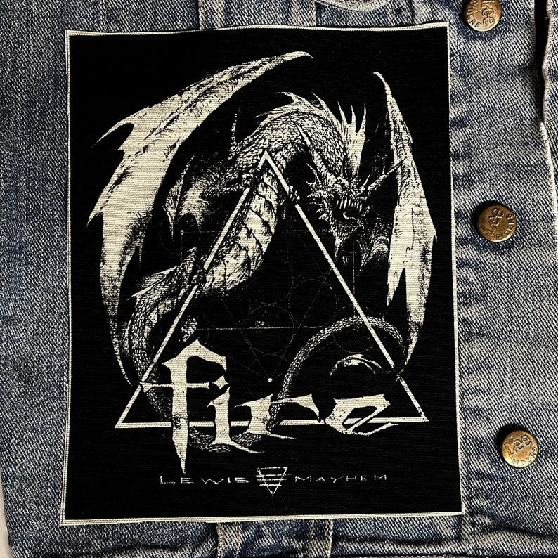 May include: Black and white embroidered patch featuring a dragon with wings spread wide, inside a triangle with the text "F.I.G. LEWIS MAYHEM" below.