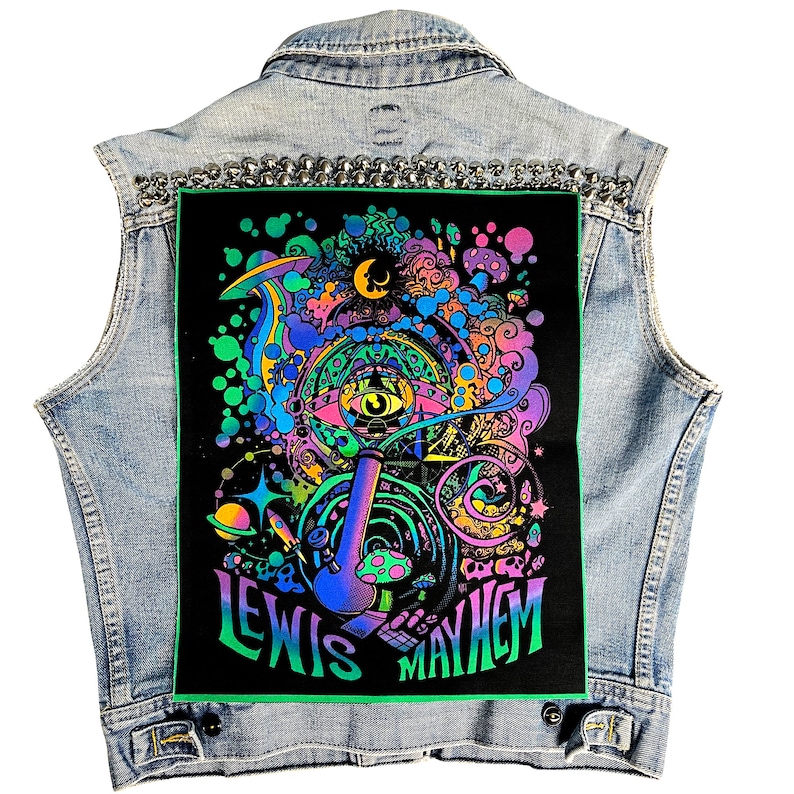 May include: A black denim vest with a colorful psychedelic patch featuring a large eye, a pipe, and the text "Lewis Mayhem".