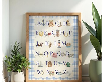 May include: A framed watercolor alphabet print featuring nautical and preppy illustrations. The print includes images of an anchor, teddy bear, croquet set, dog, shield, flag, golf bag, horseshoe, horse, knot, lighthouse, and more. The background has a blue plaid pattern.
