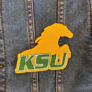 May include: A green and yellow embroidered patch with a horse and the letters "KSU".