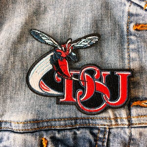 May include: A red, white, and blue embroidered patch with a stylized insect and the letters "TSU".