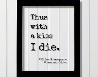 May include: A black rectangular frame containing a white print with the black typewriter-style text: Thus with a kiss I die. Below this, in smaller font, is the text: William Shakespeare, Romeo and Juliet. The design features a drop shadow effect.