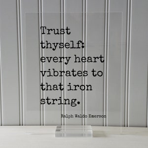 Puede incluir: Letrero de acr&iacute;lico transparente con la cita "Trust thyself: every heart vibrates to that iron string." de Ralph Waldo Emerson en texto negro. El letrero se muestra sobre una base de acr&iacute;lico transparente.