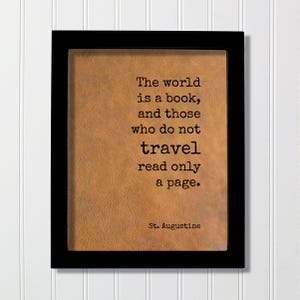 May include: A rectangular black frame containing a tan, textured background with the black printed text: The world is a book, and those who do not travel read only a page. St. Augustine. The design features a clean, simple layout with clear typography.