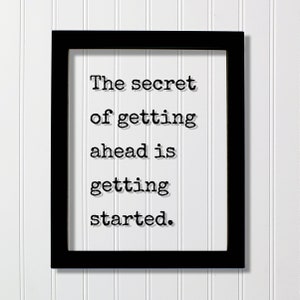May include: Black framed wall art with the quote "The secret of getting ahead is getting started."