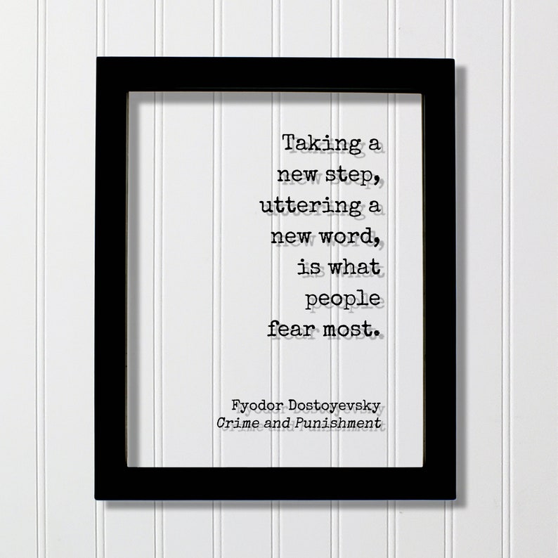 May include: Black and white framed print with a quote by Fyodor Dostoevsky from Crime and Punishment: "Taking a new step, uttering a new word, is what people fear most."
