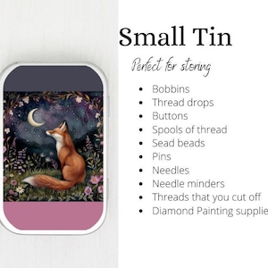 May include: A small, pink tin with a clear lid featuring a whimsical illustration of a fox gazing at a crescent moon in a starry night sky. The tin is ideal for storing small items such as bobbins, thread drops, buttons, spools of thread, beads, pins, needles, and more.