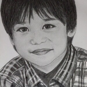 May include: A black and white pencil drawing of a young boy with short dark hair. He is wearing a plaid shirt with a black and white pattern.