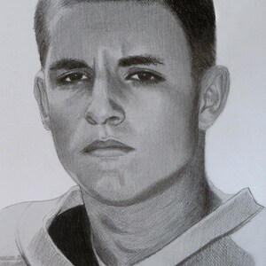 May include: A black and white pencil drawing of a person's face. The person has short, dark hair and is wearing a collared shirt. The person has a serious expression on their face.