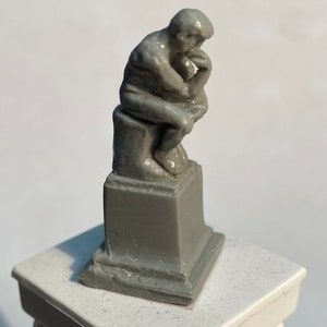 The Thinker Statue - Miniature version of the famous statue in the gardens of the Rodin Museum in Paris