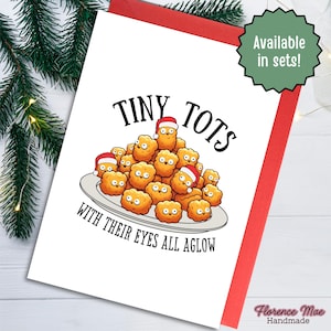 May include: A white greeting card featuring a cartoon illustration of a pile of golden-brown tater tots on a plate. Some tots wear small red Santa hats. The text reads TINY TOTS WITH THEIR EYES ALL AGLOW in black capital letters.