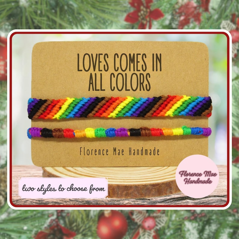 May include: Two woven bracelets displayed on a rectangular tan card with the text LOVES COMES IN ALL COLORS and Florence Mae Handmade. The top bracelet features a diagonal rainbow stripe pattern, while the bottom bracelet has a knotted design.