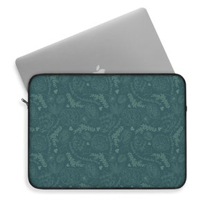 May include: Teal laptop sleeve with a white floral pattern and the text "remarkably good" repeated throughout the design.