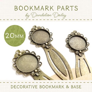 May include: Three antique gold-toned bookmark bases with 20mm round decorative bezels. The bezels have a floral design and are ready to be filled with resin or other embellishments.  The bookmark bases are made of metal and have a textured finish.  The text "BOOKMARK PARTS by Dandelion Doiley" and "DECORATIVE BOOKMARK & BASE" are visible in the image.