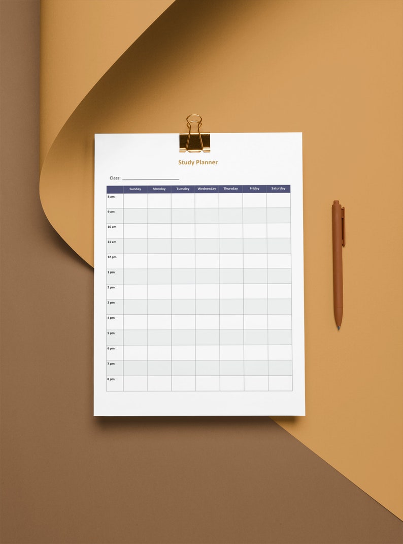 May include: A white study planner with a gold binder clip and a brown pen. The planner has a grid layout for scheduling classes from Sunday to Saturday, with time slots from 8 am to 8 pm. The words "Study Planner" are at the top.