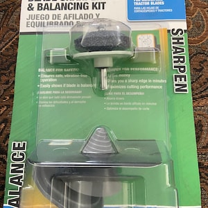 May include: A green and white package with a black and gray blade sharpening and balancing kit. The kit includes a sharpening stone and a balancing tool. The package says "Arnold Blade Sharpening & Balancing Kit" and "Universal for Mower and Tractor Blades".