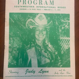 May include: A vintage program for the Southwestern International Rodeo, featuring a photo of Judy Lynn, a country music singer, in a cowboy hat. The program is dated February 6-11, 1973, and is priced at 25 cents.