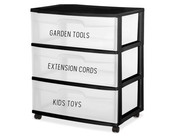 May include: A black plastic storage unit with three clear drawers on wheels. Each drawer features a black label with white text: the top drawer reads GARDEN TOOLS, the middle drawer reads EXTENSION CORDS, and the bottom drawer reads KIDS TOYS.
