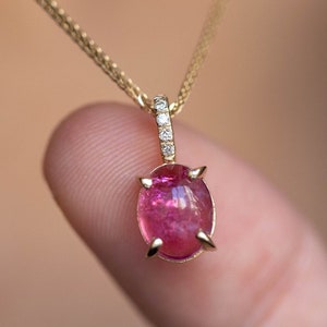 Pink tourmaline pendant necklace in 14K yellow gold. The ring on top of the pendant has five diamonds pave set that add extra glam.