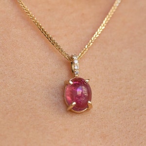 Pink tourmaline and diamonds necklace for women in 14K gold. The pendant is a great choice for a birthday gift as tourmaline is the October birthstone.