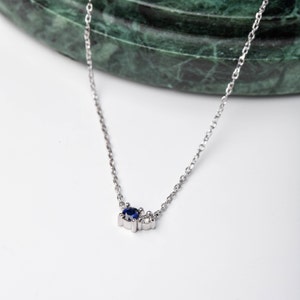 14K white gold necklace for women with a blue sapphire 3mm and a clear diamond 2mm.