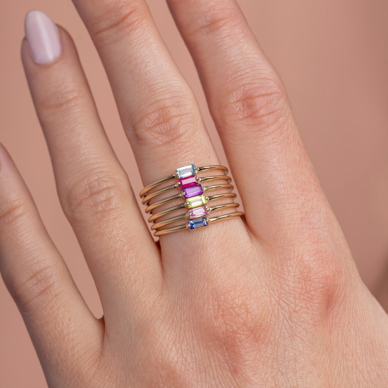 Stacking gemstone rings in 14K solid gold. The stones available are, from the top, Swiss blue topaz, ruby, purple amethyst, peridot, pink sapphire, blue sapphire.