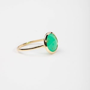 Side view of a 14K solid yellow gold ring with a genuine green chrysoprase gemstone.