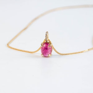 14K gold necklace with natural gemstones. The pendant has as main stone an oval pink tourmaline and it also has 5 diamonds on the bail.