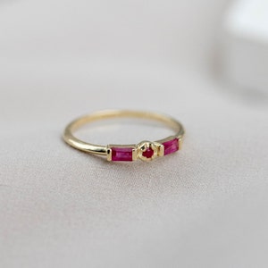 Dainty stacking solid gold ring with natural rubies. It is a great birthday gift for women, as ruby is the July birthstone.
