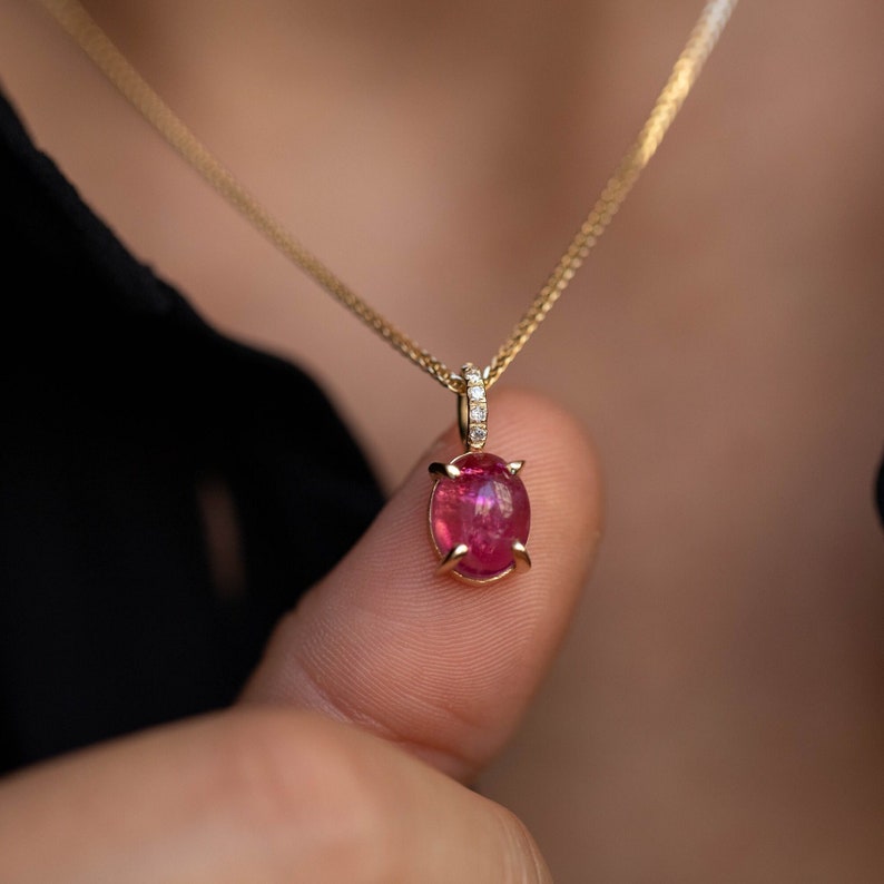 Natural gemstone pendant in 14K solid gold. The gemstones are an oval pink tourmaline a 5 clear brilliant diamonds.