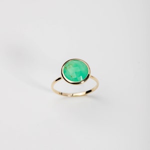 Dainty solid gold ring with a natural green chrysoprase gemstone on top.