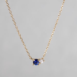 Vivid blue sapphire and diamond necklace in prong set. The metal used is 14K yellow gold.