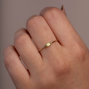 Dainty 14K yellow gold ring with a genuine peridot gemstone in baguette cut