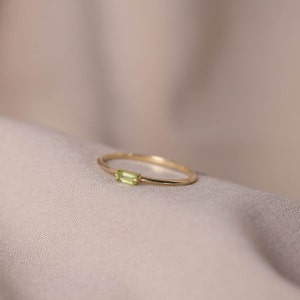 Genuine peridot gemstone ring in 14k solid gold, dainty and minimalist, ideal for stacking with more thin rings.