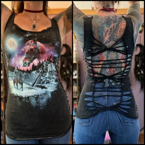 May include: A black tank top with a galaxy print and a horse on the front. The back of the tank top has been cut and tied to create a criss-cross design.