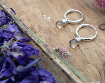 Small hoop earrings, with transparant smokey quartz gemstone drops, without facets, like waterdrops. Sterling silver