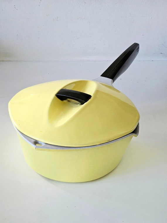 Box of vintage kitchenware inc Le creuset cast iron saucepans with blue