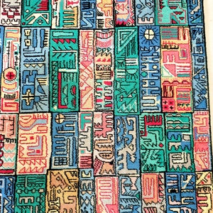 May include: A colorful rug with a geometric pattern. The rug features a repeating design of rectangular blocks in shades of teal, blue, pink, yellow, and red. The blocks are filled with abstract shapes and lines, creating a vibrant and eye-catching design.