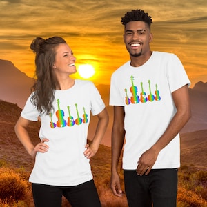 May include: Two people wearing white t-shirts with a rainbow design of musical instruments. The design features a violin, guitar, and ukulele.