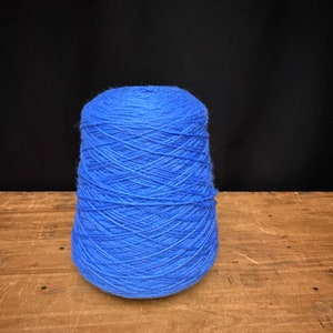 May include: A cone of blue yarn.