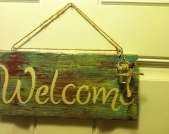Welcome sign with metal pail and flowers