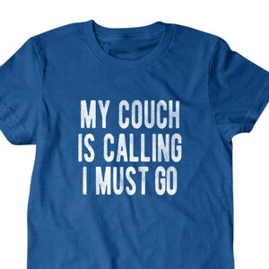 May include: A royal blue t-shirt with the text "My couch is calling I must go" printed in white.