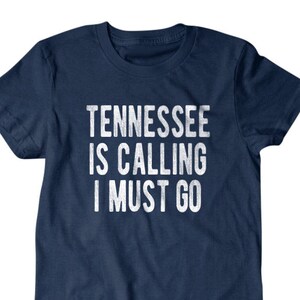 May include: A navy blue t-shirt with the text "Tennessee is calling I must go" in white.