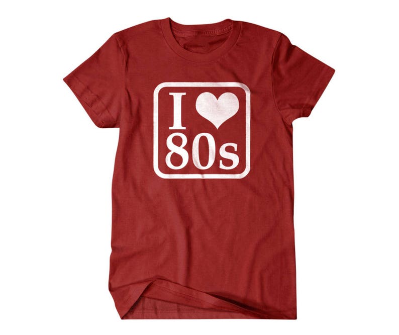 May include: Red t-shirt with a white square graphic that says "I love 80s" with a heart in place of the "O".