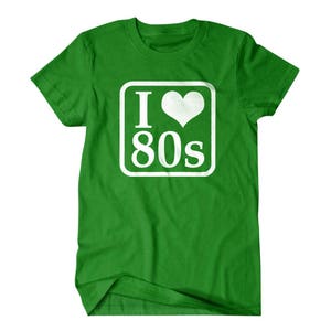 May include: Green t-shirt with a white square graphic that says "I love 80s" with a heart in place of the "o".